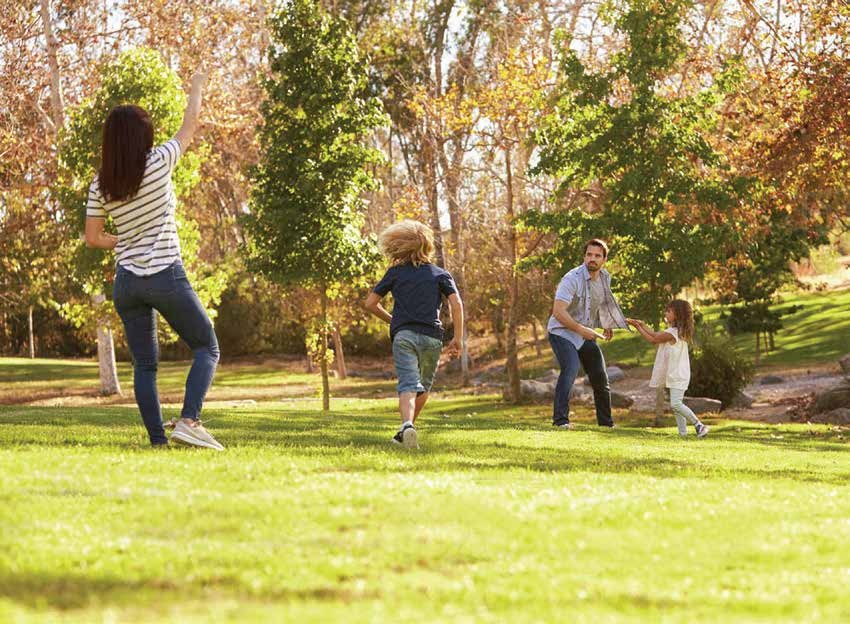 Family spending time outdoors in a green park